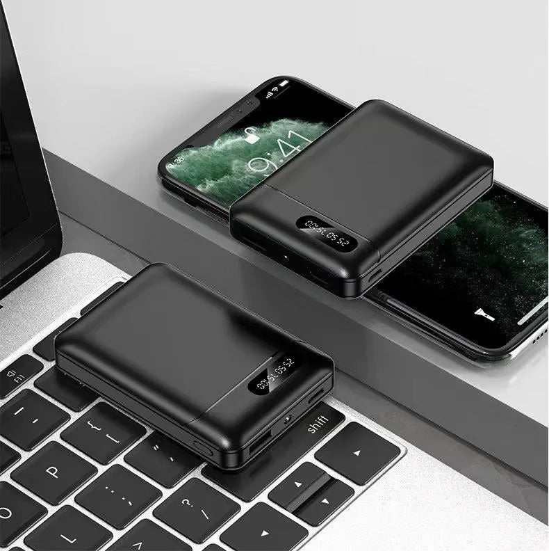 Black and white portable power bank showing USB ports and compact rectangular design