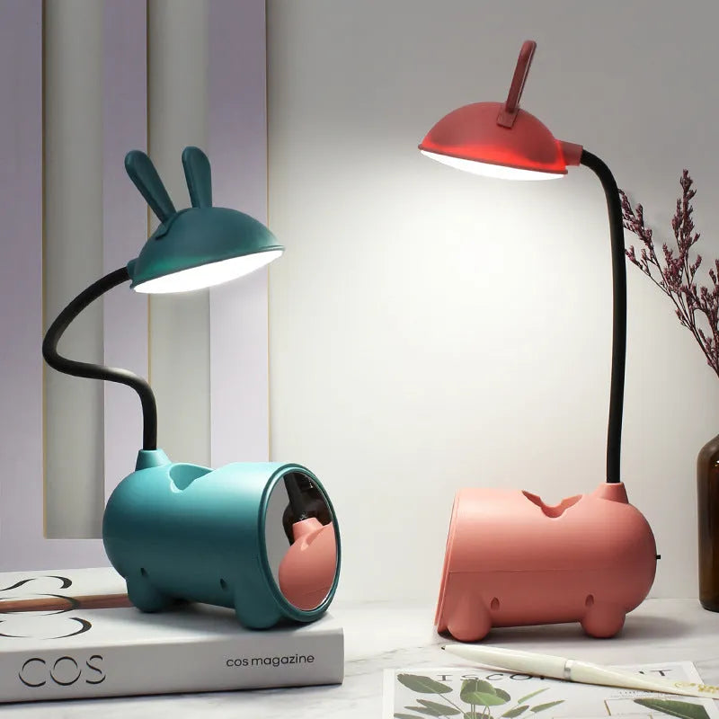 Cartoon-themed USB table lamp with pen container in green, dark blue, or pink plastic