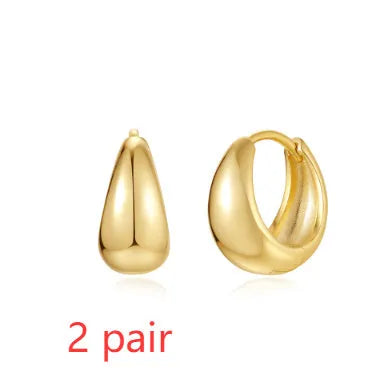 Golden geometric clip-on earrings with round design elements and electroplated finish