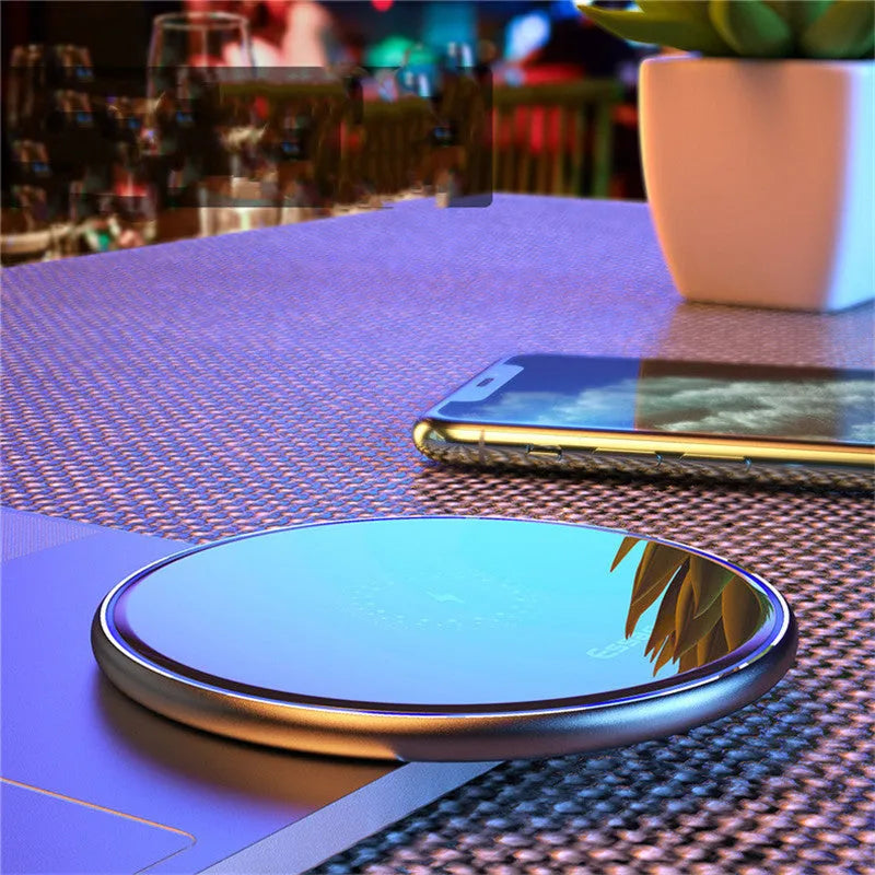 Black or white 15W Qi fast wireless charging pad with LED indicator light on anti-slip aluminium base.
