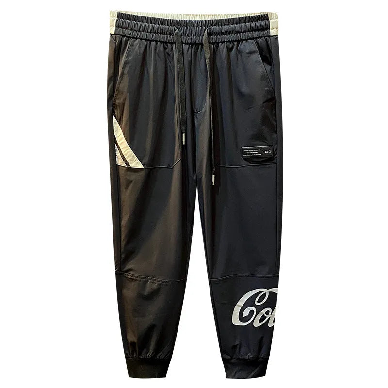 Black men's ultra-thin cotton ankle banded cropped trousers laid flat showing casual design