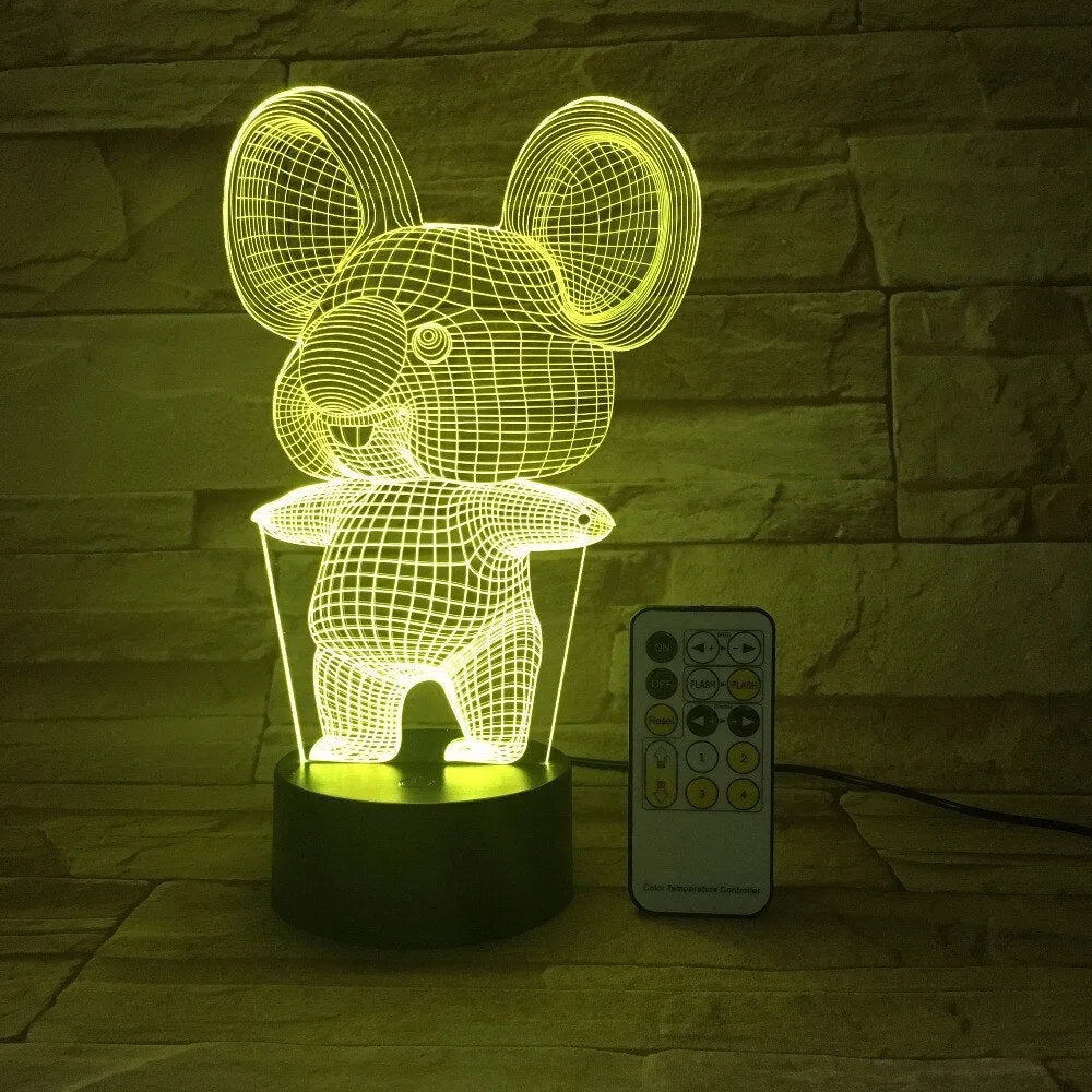 Black koala-shaped LED night light on a table showing multi-colour glow options including red, green, blue, and purple.