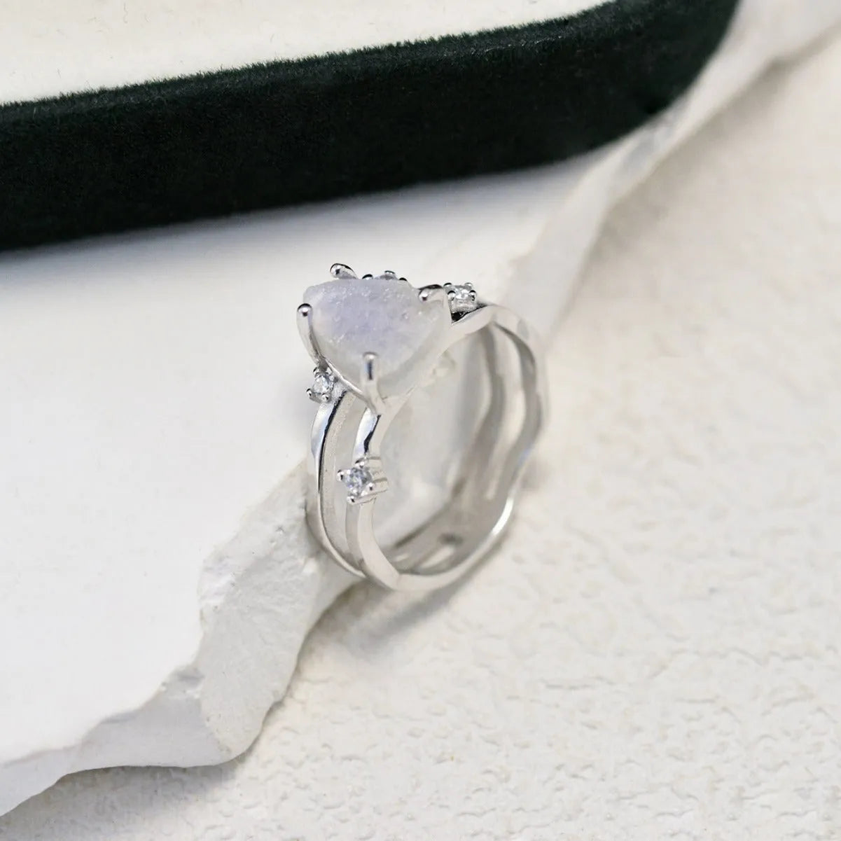 S925 silver irregular triangle moonstone ring in rose gold, white gold, or yellow gold colour on a hand.
