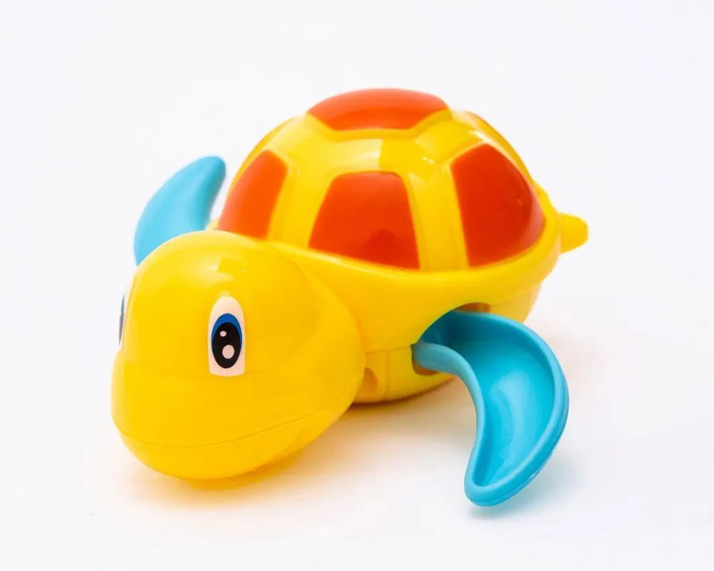 Yellow wind-up plastic turtle water toy on blue surface, 12cm clockwork mechanism