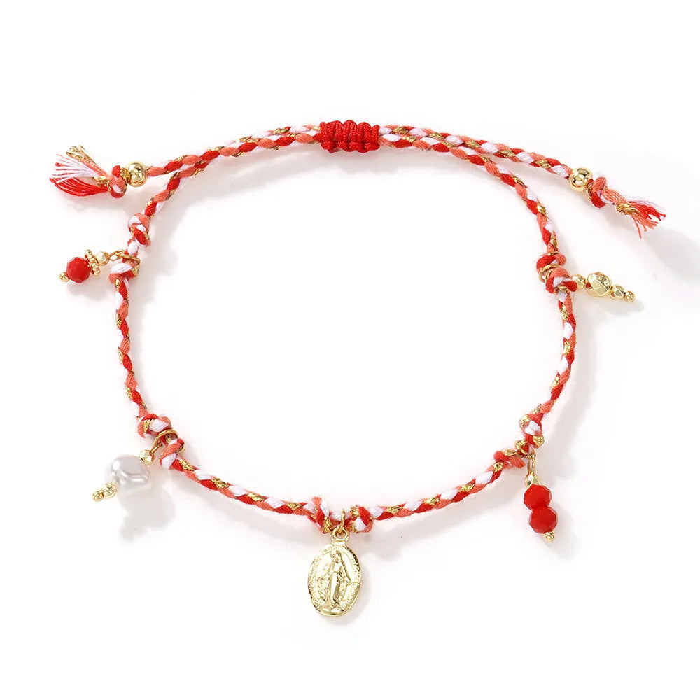 Close-up of a hand-woven colourful braided rope bracelet for women with an integrated fabric strap tag.