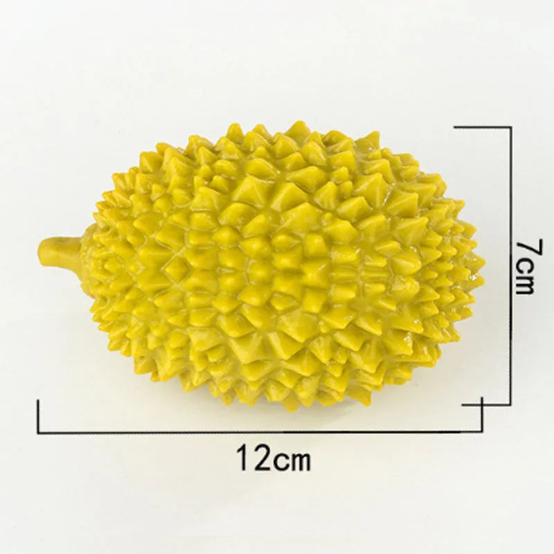 Durian-shaped milk-flavoured dog chew toy in beige with raised bumps for teeth cleaning and a bonus ball