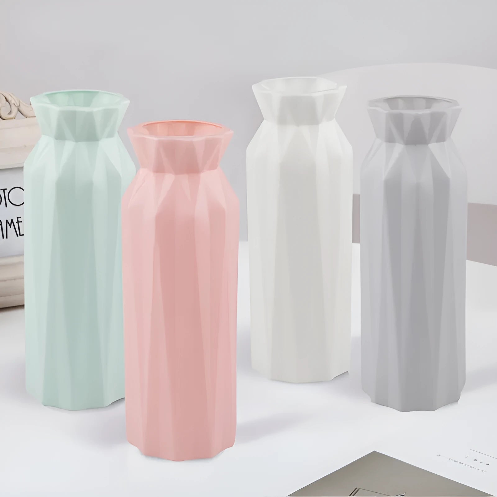 Green melamine plastic vase with 7.2cm base on a wooden table.