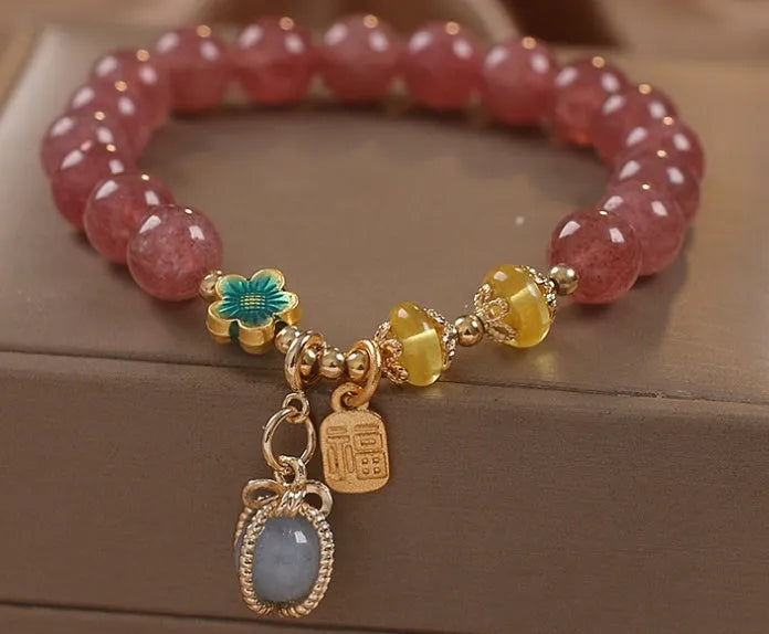 Red strawberry quartz design beaded bracelet for women with alloy metal and rhinestones.