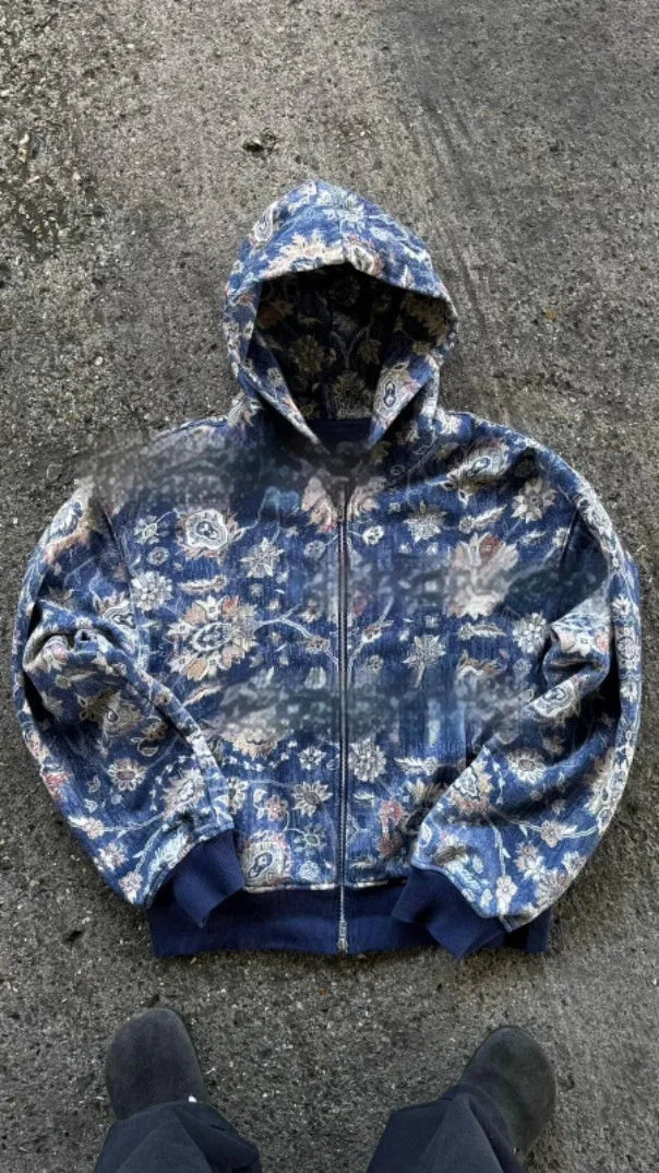 A blue loose-fitting men's hooded zip coat with long sleeves, shown on a hanger.