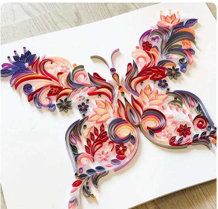 20 inch handmade butterfly quilling paper ornament with assembly tools on blue background