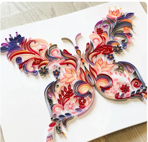 20 inch handmade butterfly quilling paper ornament with assembly tools on blue background
