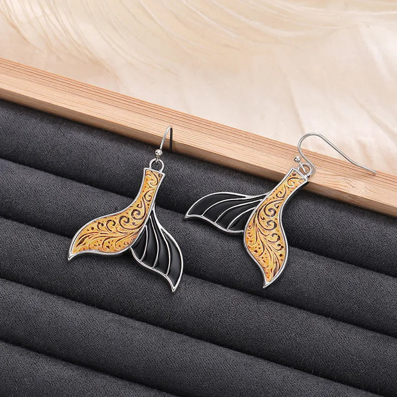Women's white gold fishtail earrings with whale design elements in retro style