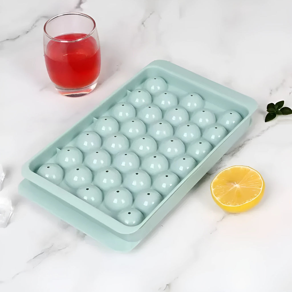 Blue silicone ice cube tray with lid showing 33 round compartments for making ice balls
