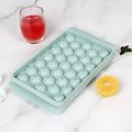 Blue silicone ice cube tray with lid showing 33 round compartments for making ice balls
