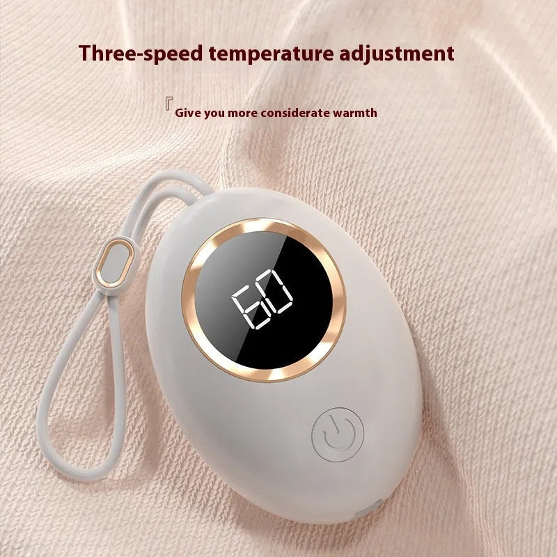 USB-powered hand warmer with digital display showing battery level and heat settings