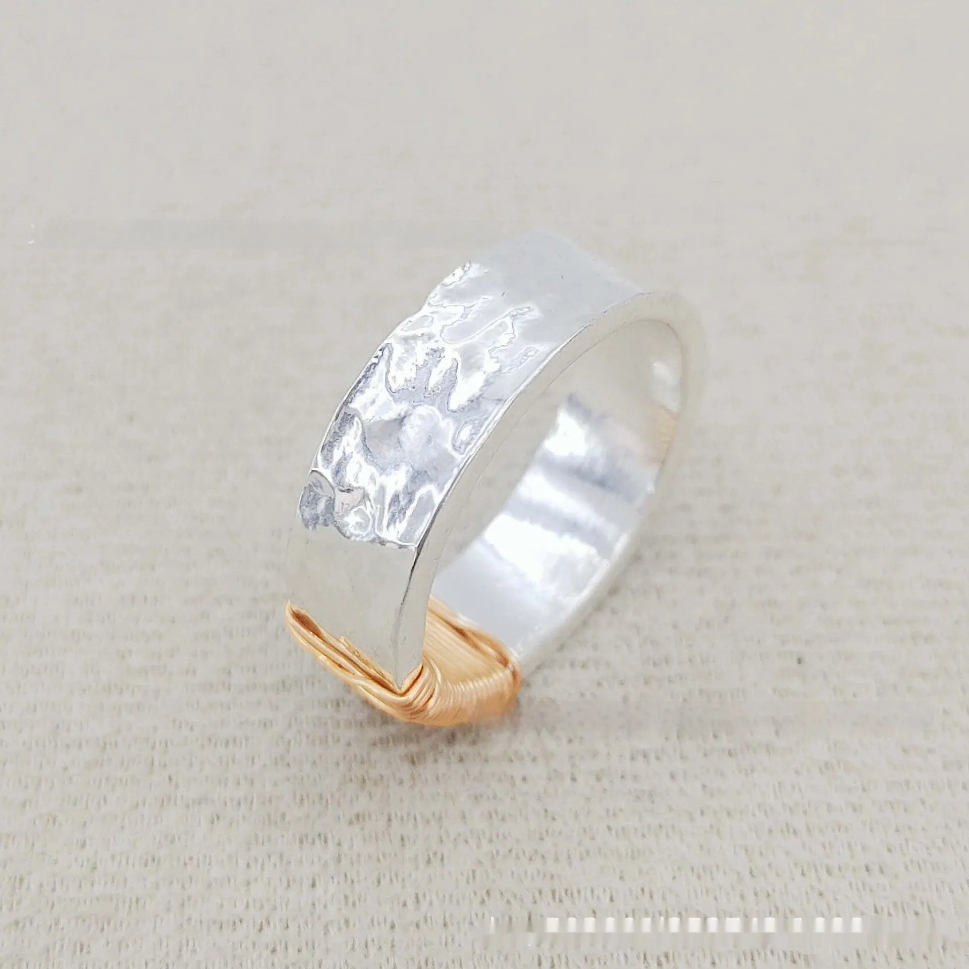 Copper bracelet ring with geometric coil design in silver gold colour on wrist