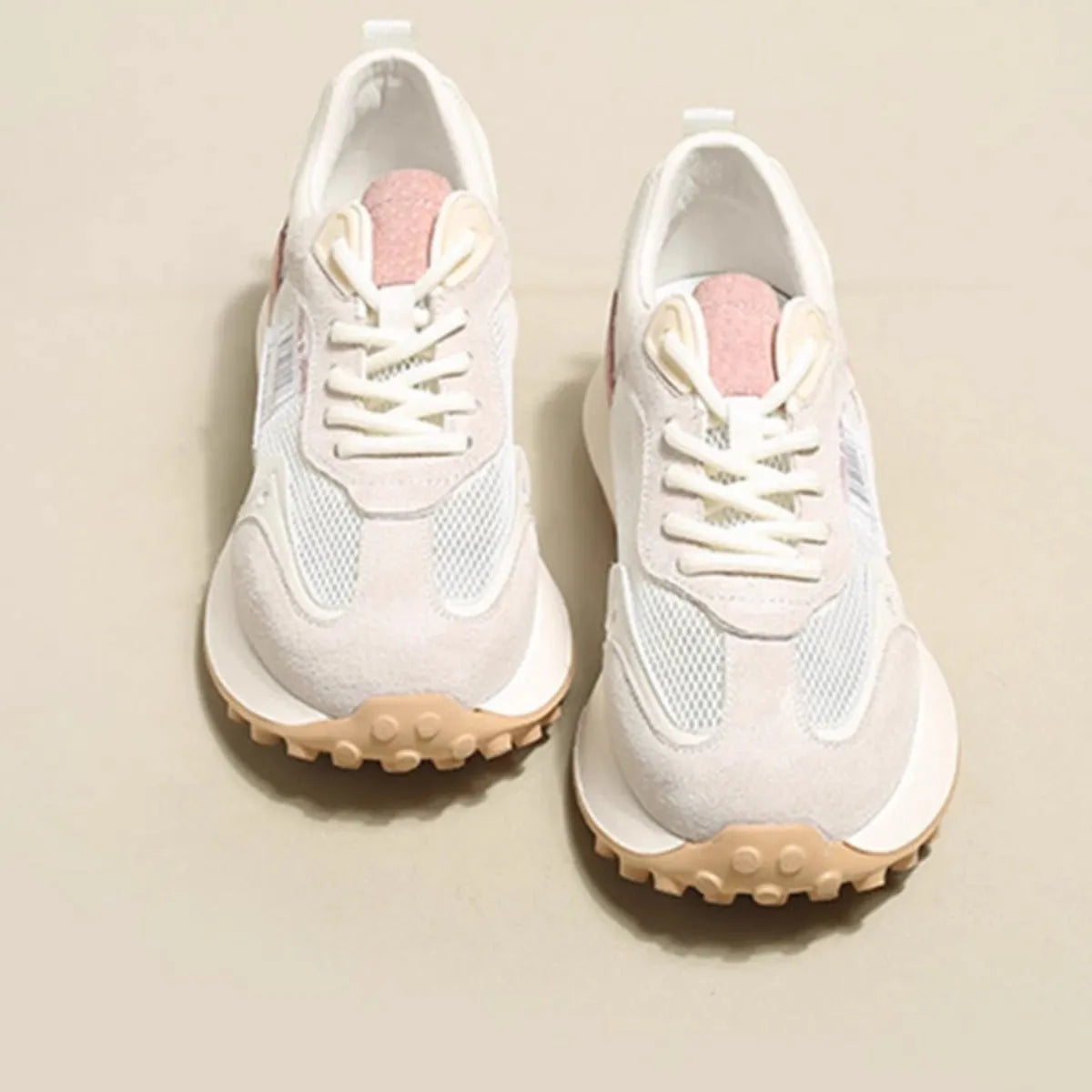 Women's grey and pink low-top retro sneakers with a round toe and flat rubber sole.