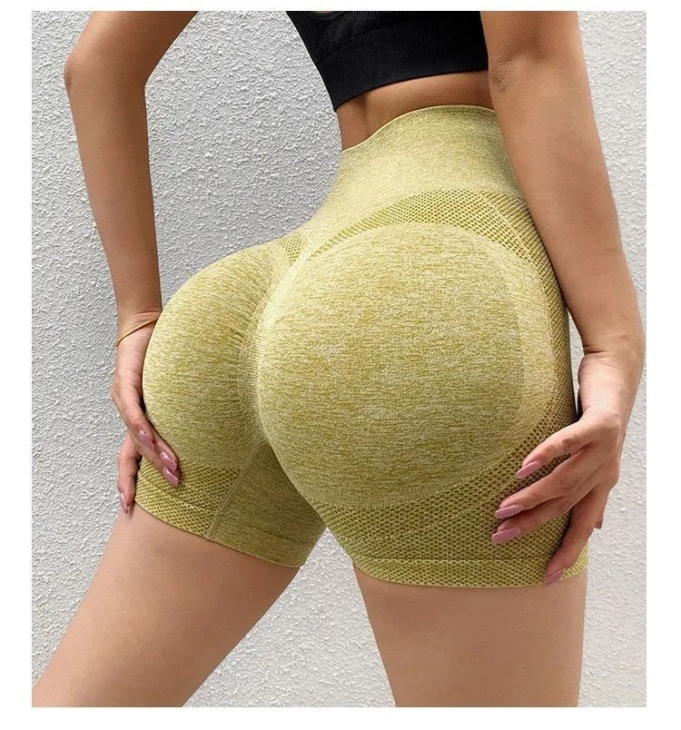 Woman wearing high-waisted black quick-dry yoga fitness shorts with a seamless waistband.