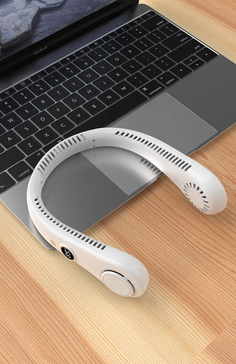 Pink bladeless neck fan hanging with USB cable for charging.