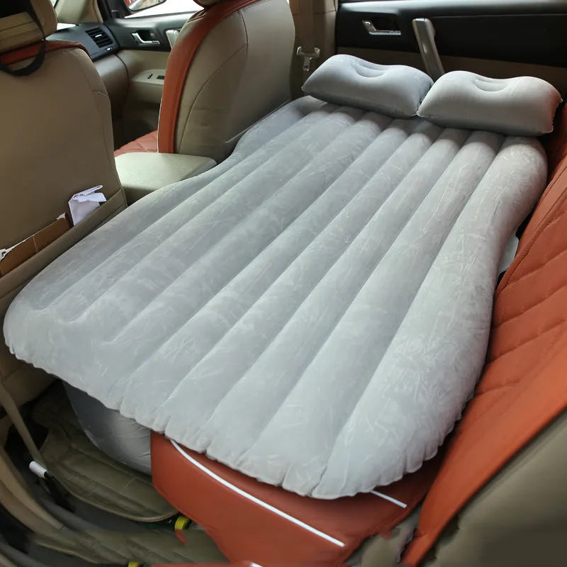 Ultra-thickened flocking cloth inflatable bed set up on a car rear seat with two pillows.