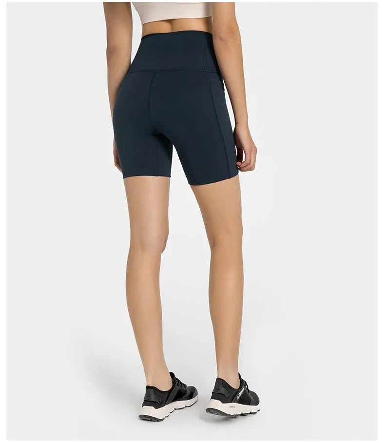 Women's tight-fit cotton blend sports shorts in light purple lotus colour, showing short fifth pants length.