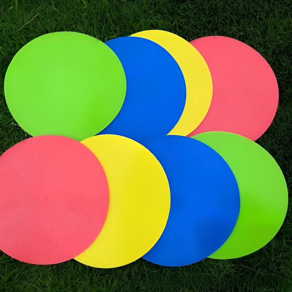Soft yellow football training target pad, 23cm diameter flat disc on grass.