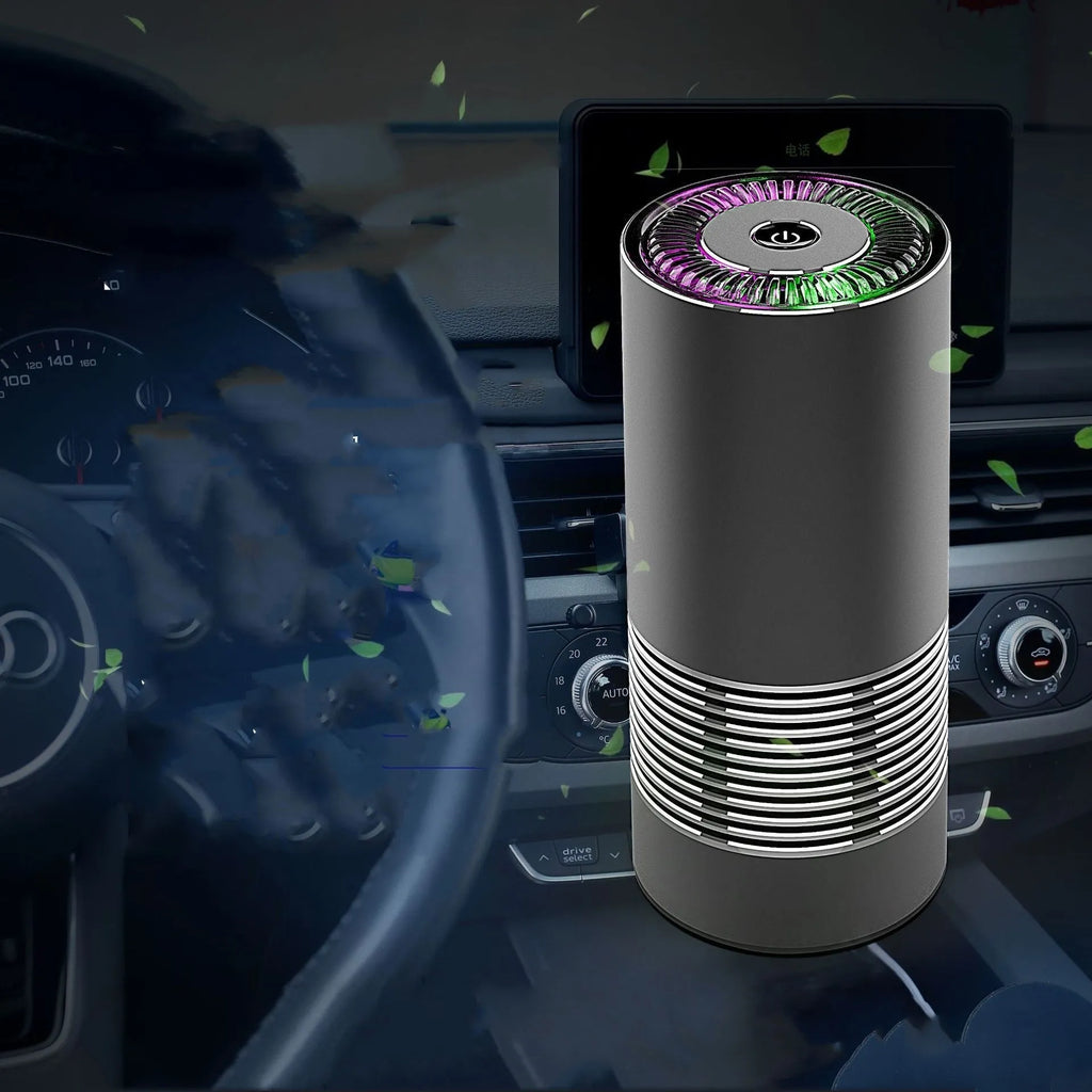 Compact black metallic car air purifier with USB cable on a car dashboard.