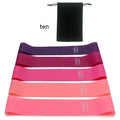 Five yoga resistance bands in different colours with varying thickness for progressive fitness training