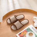 Women's open-toe linen slipper in a light brown colour, showing the breathable design and thickening sole.