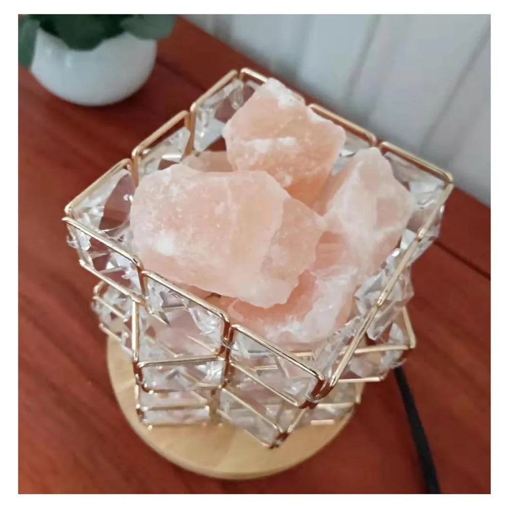 Himalayan crystal salt lamp with dimmer switch on wooden base emitting warm amber glow