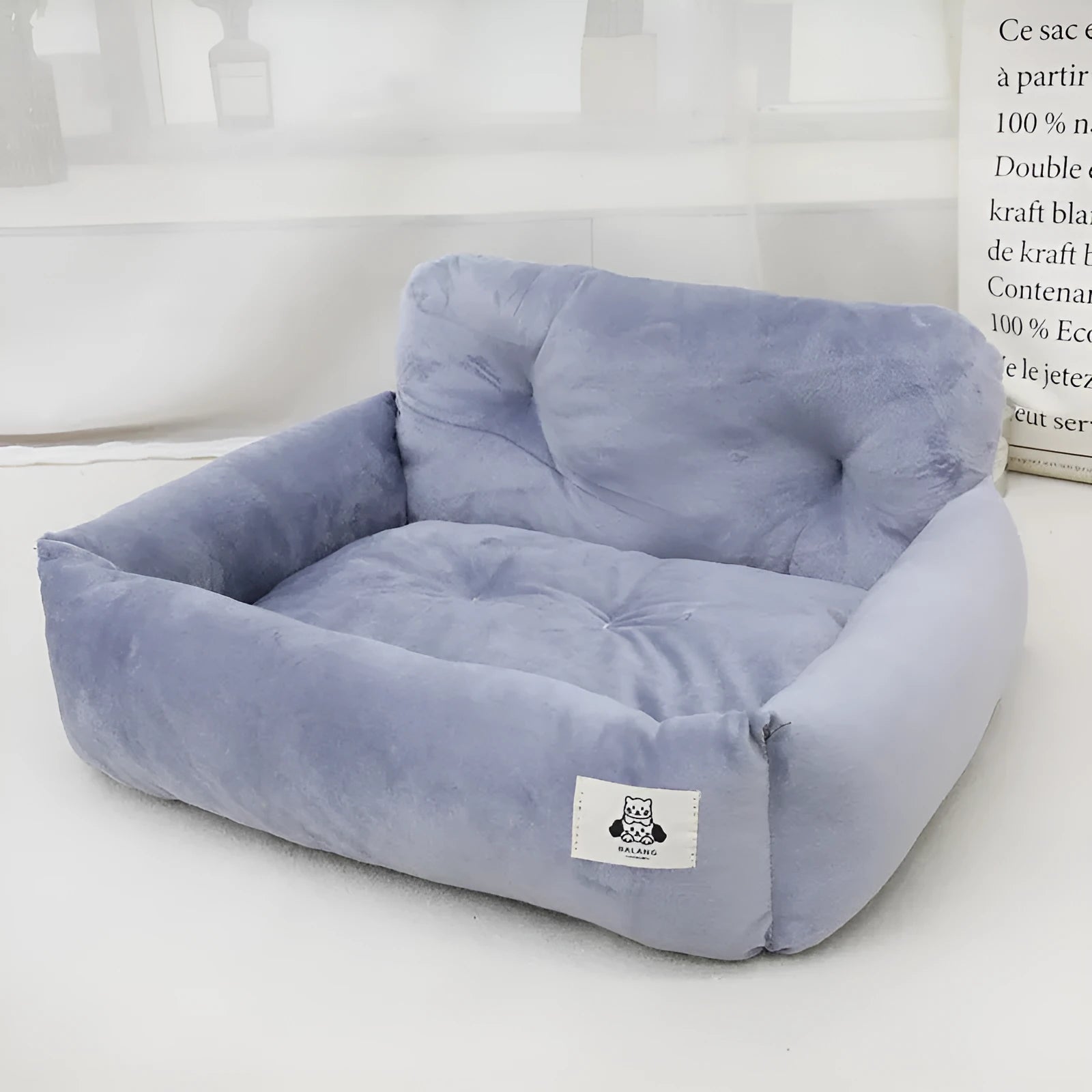 Car-mounted dog travel nest in stain-resistant cloth showing grey and blue plaid colour options