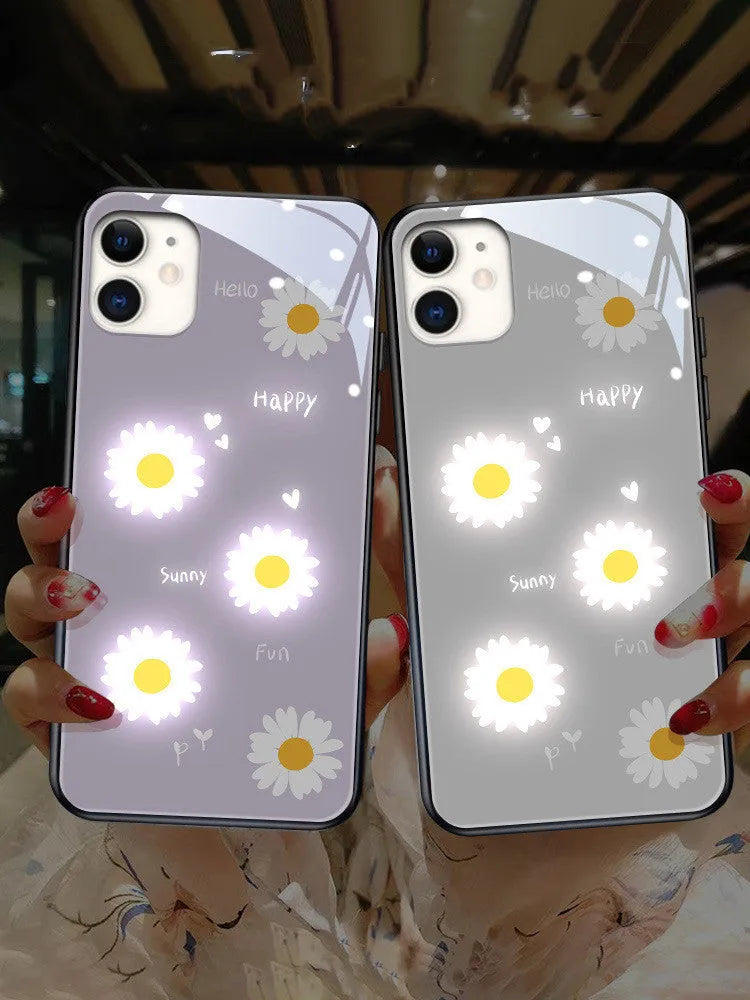 White luminous iPhone case with painted purple daisies and a voice-activated light, shown on a phone.