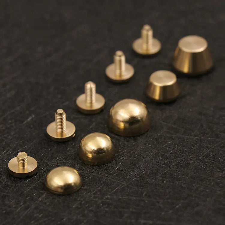 Solid brass decorative buckle for clothing in round and geometric foot nail designs.