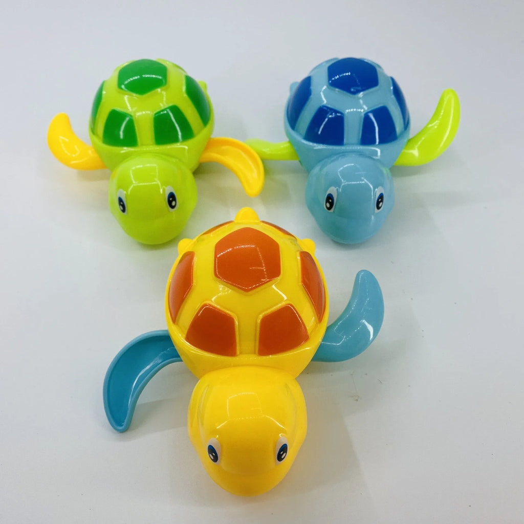 Yellow wind-up plastic turtle water toy on blue surface, 12cm clockwork mechanism