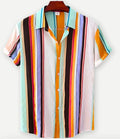 Man wearing a short sleeve Hawaiian shirt with a colourful floral print pattern.