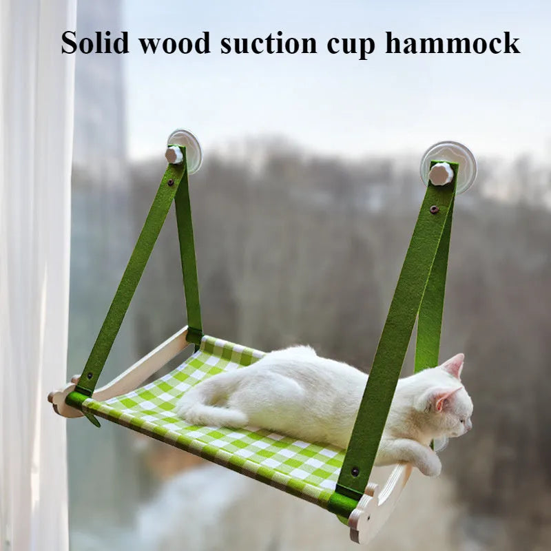 Pink wooden cat hammock bed with suction cups attached to a window