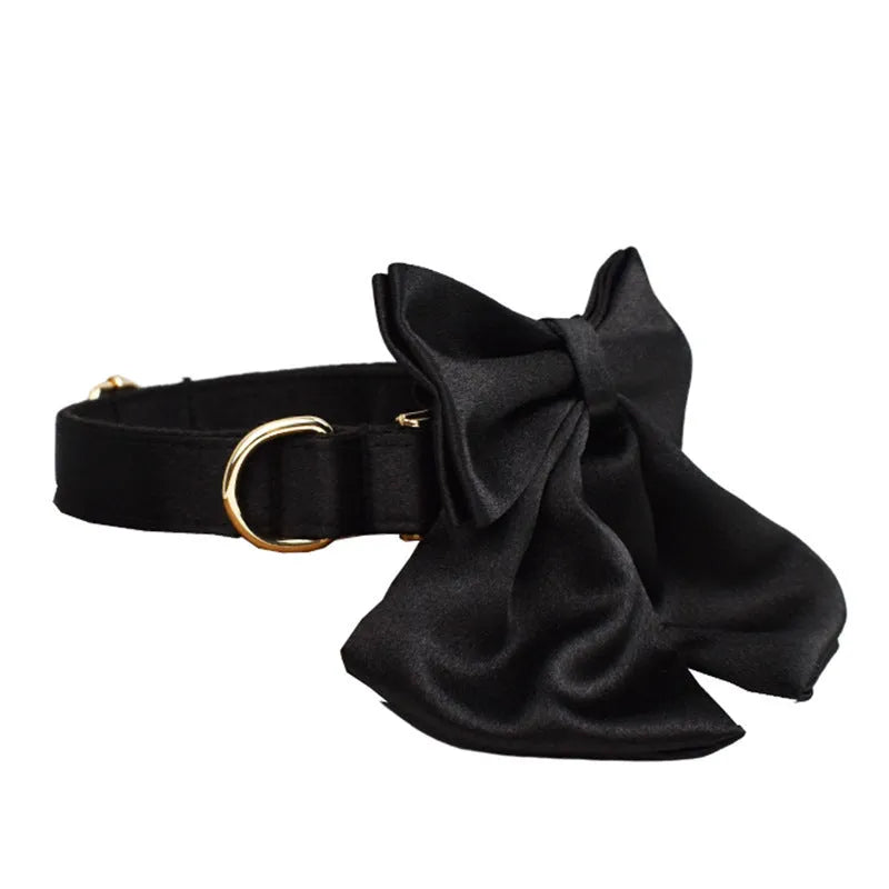 A complete cloth dog accessory set showing a collar, leash, chest strap, vest, and decorative bow in matching colours.
