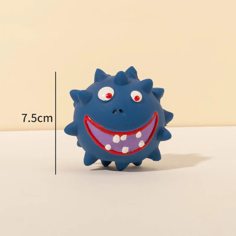 Four colourful squeaky dog balls with cute faces on textured natural latex rubber surfaces