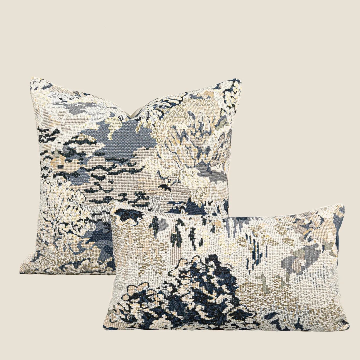 Antique blue abstract floral decorative pillow on a grey sofa, showing square and waist pillow sizes.