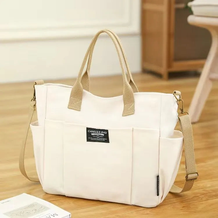 Canvas shoulder bag in khaki, 31cm wide, with handle and crossbody strap, urban simplicity style