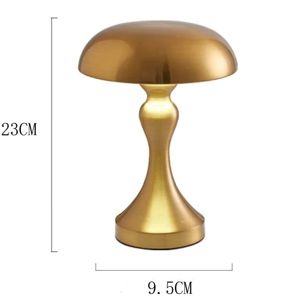 Bronze finish USB rechargeable desk lamp with touch control for three light colours on a wooden desk.
