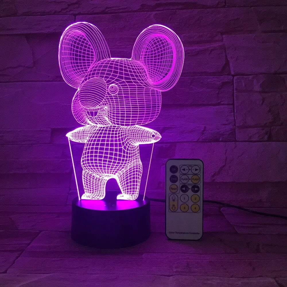 Black koala-shaped LED night light on a table showing multi-colour glow options including red, green, blue, and purple.