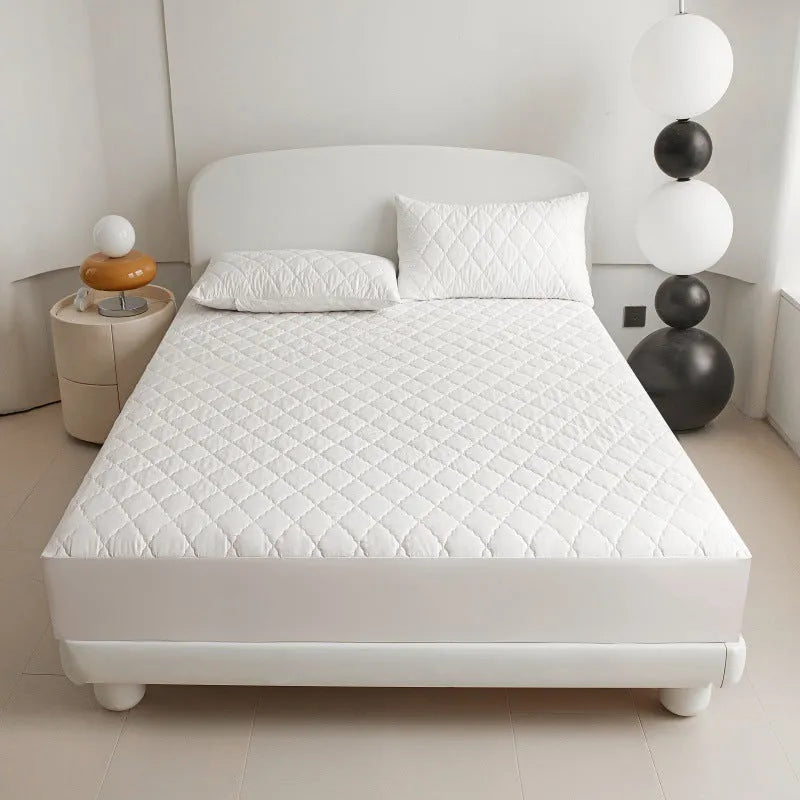 Diamond lattice quilted bamboo fibre waterproof mattress protector set with fitted sheet and pillowcases in grey.