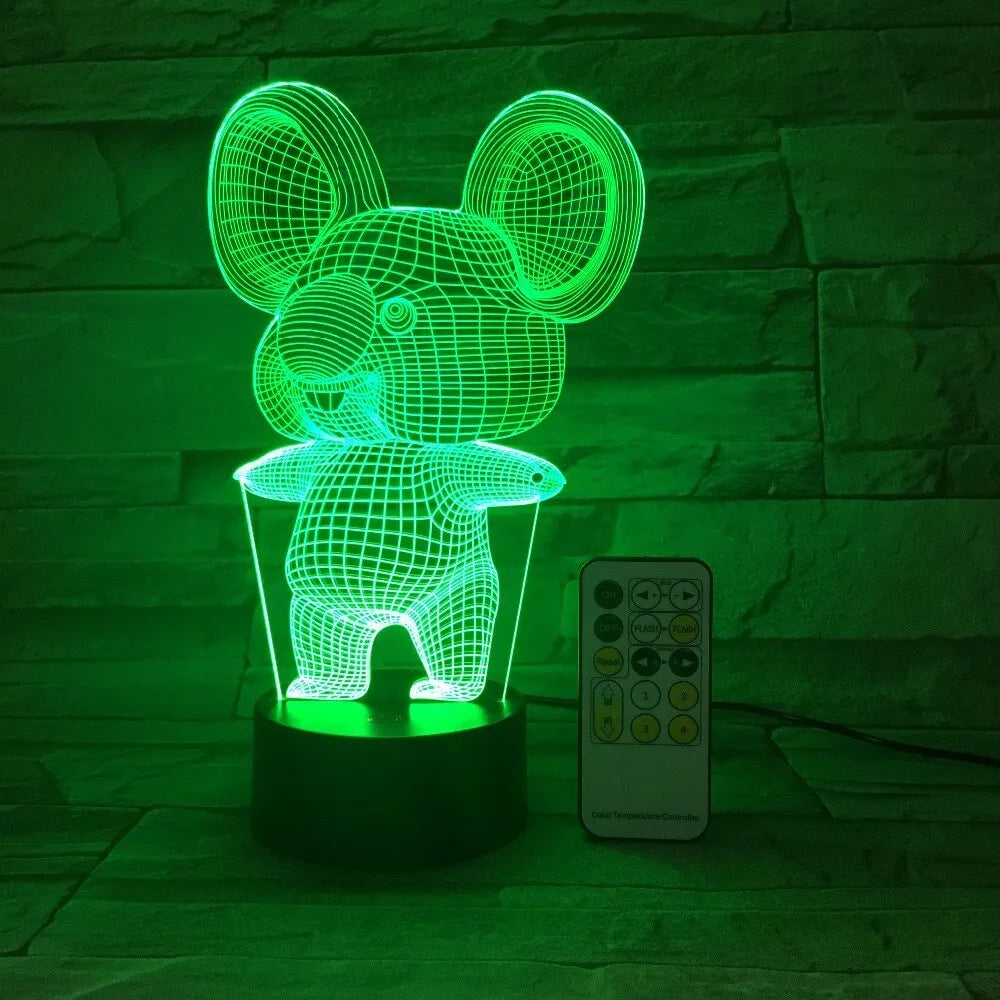 Black koala-shaped LED night light on a table showing multi-colour glow options including red, green, blue, and purple.
