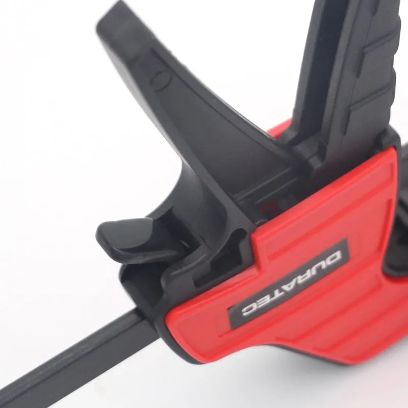 Black plastic quick-adjust woodworking clamp with rubber grips, shown in various sizes.