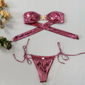 Women's glossy sapphire blue bikini with gold starfish print, showing backless two-piece design.