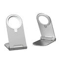 Silver vertical adjustable magnetic phone bracket for iPhone 12 models on a desk.