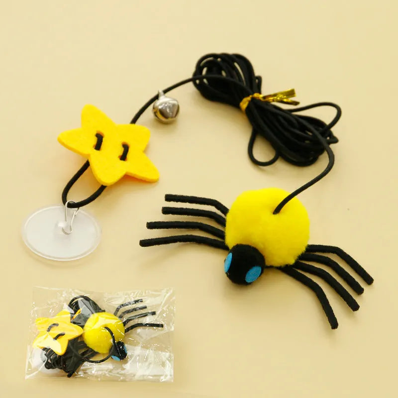 Red cat toy hanging from door with elastic rope, feather stick, bell, and spider decoration