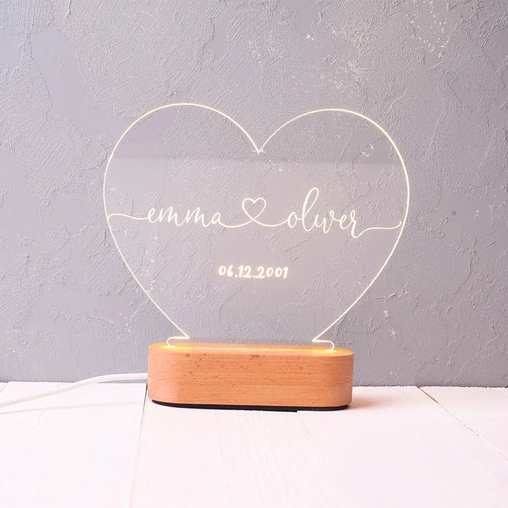 Personalised acrylic night light with engraved names and dates, measuring 20cm by 11.5cm
