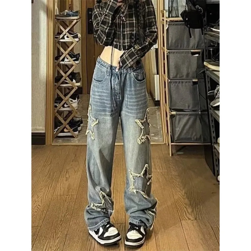 Blue high waist women's wide-leg denim trousers laid flat, showing straight leg cut and button fastening.
